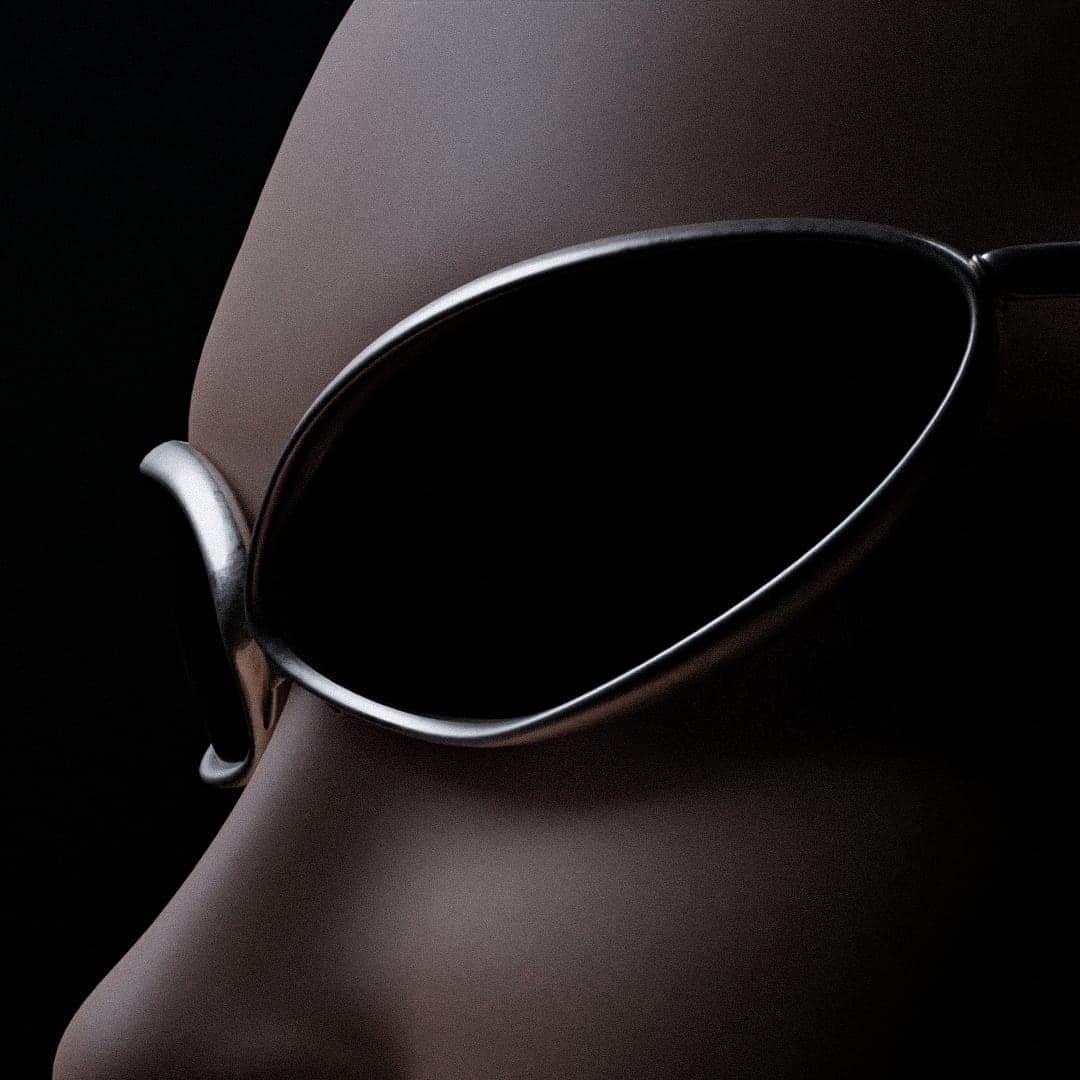 The metal frame worn, photographed close on a dark mannequin face, the rim catching a hard highlight.