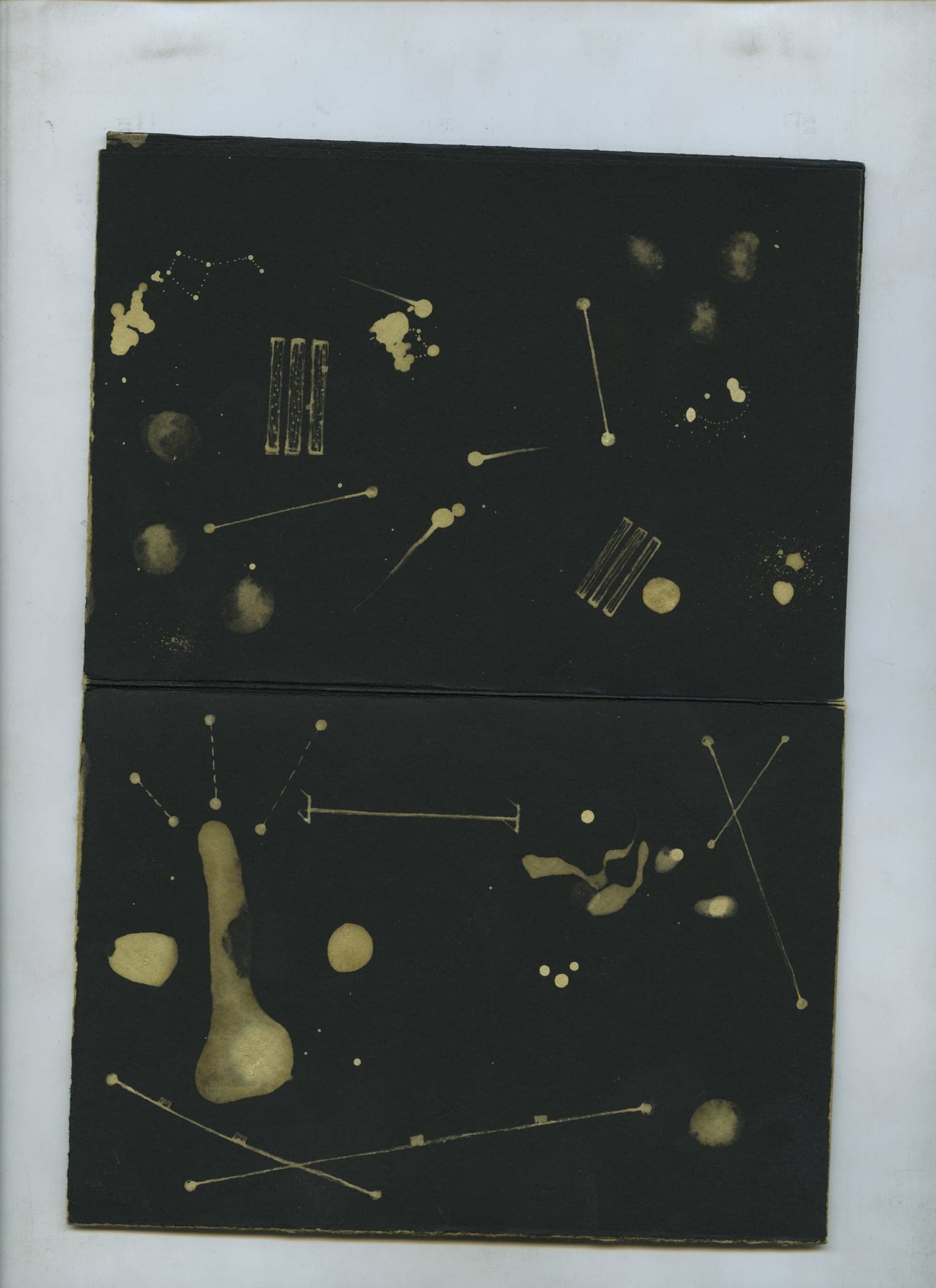 A quiet spread of pale dots, ruled lines and small bleached blobs joined like a star chart across both pages