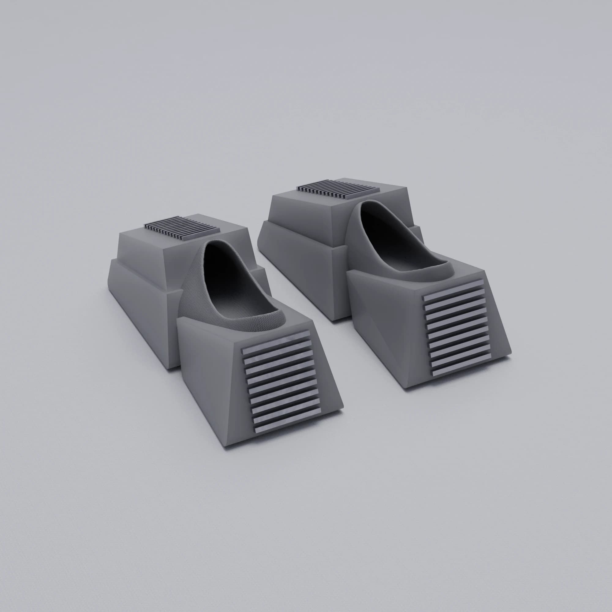 A pair of grey block shoes on a pale ground, each a stepped wedge with a louvred toe panel and an oval opening for the foot.