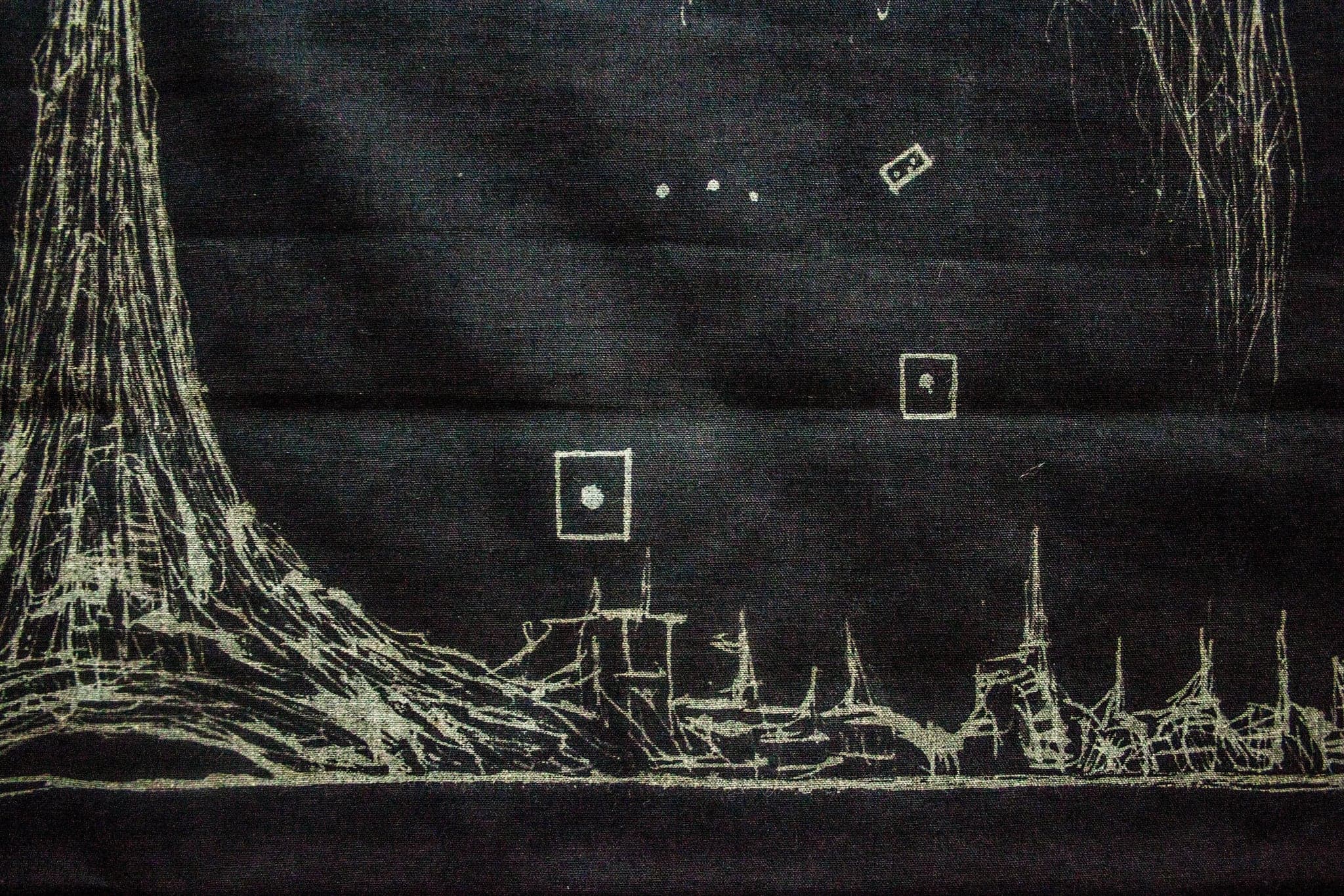 Close view of the lower band of the cloth: a bleached skyline of thin towers along the bottom, a broad tapering mass at the left, and two small framed dot-signs floating in the dark field above.