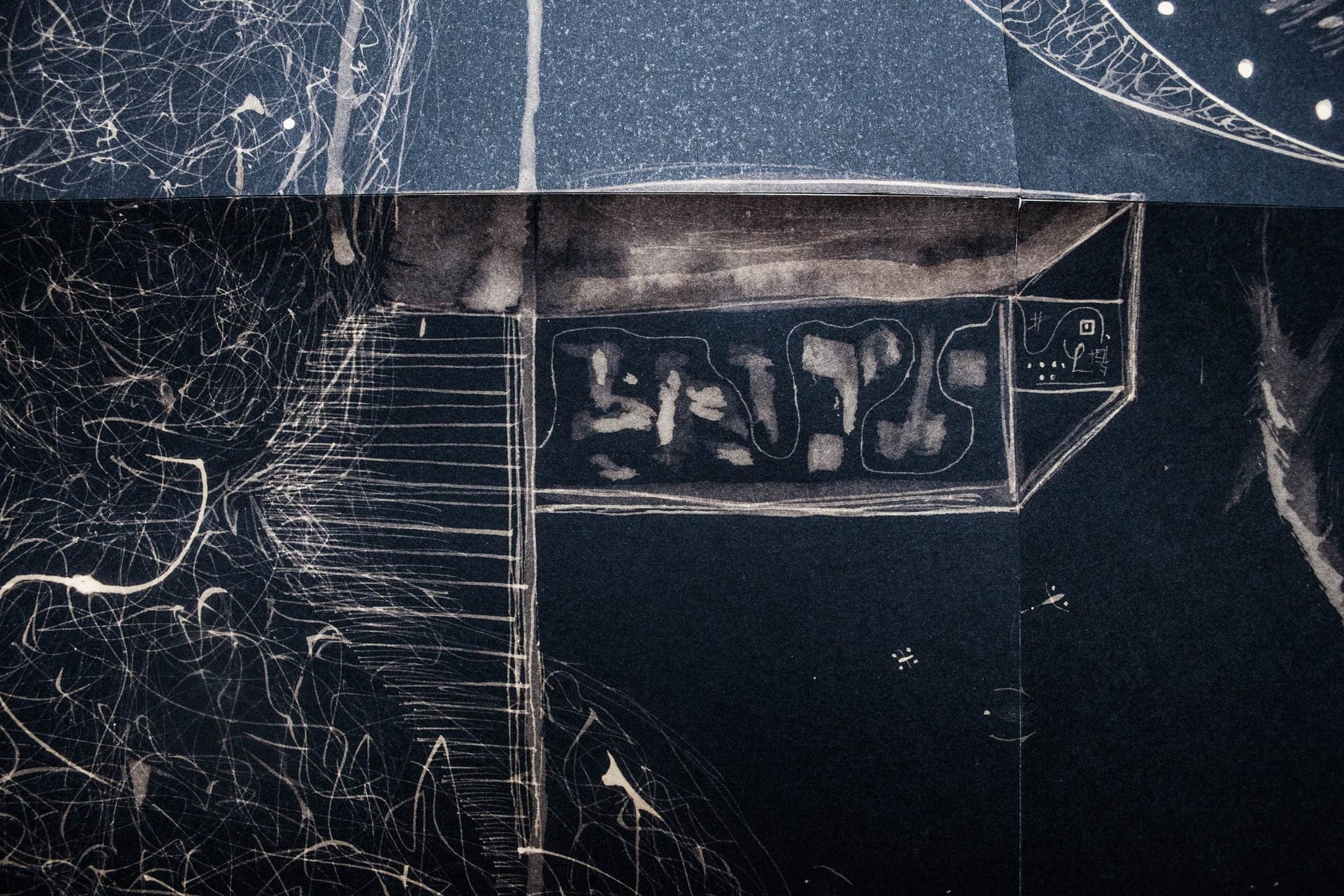 A wide sheet with a lit panel and a beam running across, small drawn objects gathered underneath.