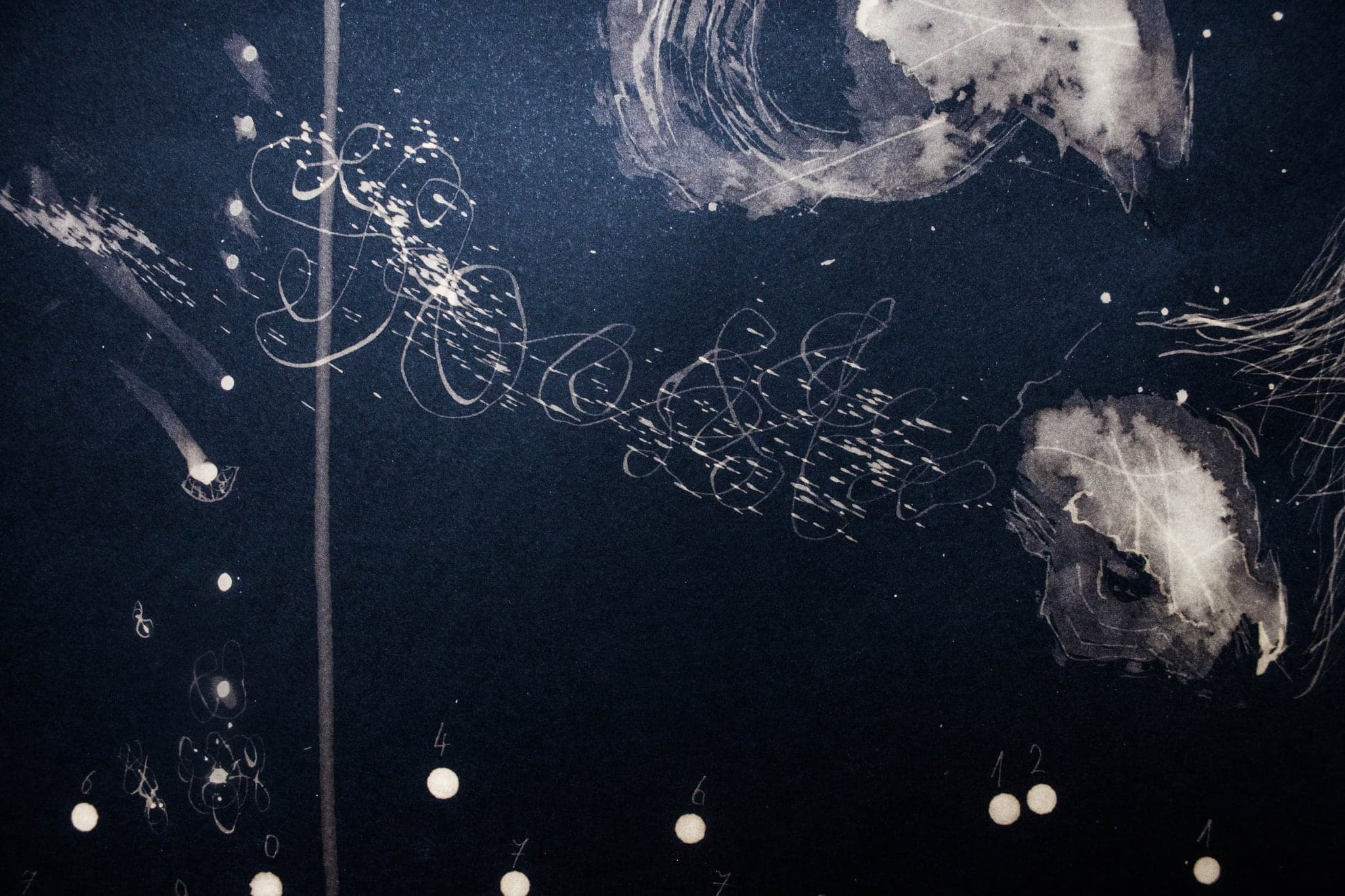 Pale cloud-like blooms and scattered points of light across deep blue.