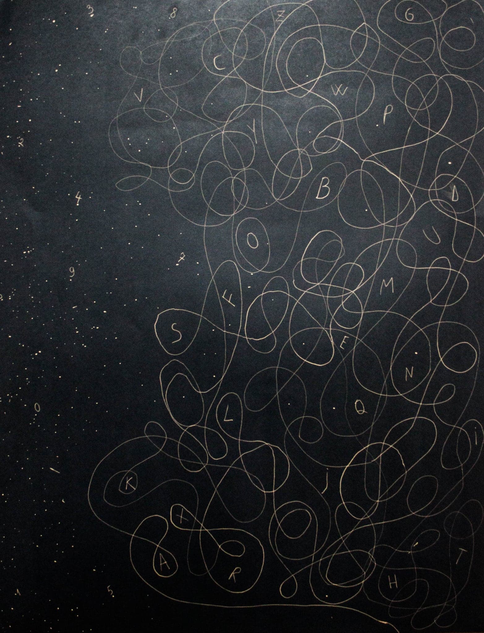 A faint tangle of loops filling the whole sheet, barely lifted out of the dark.
