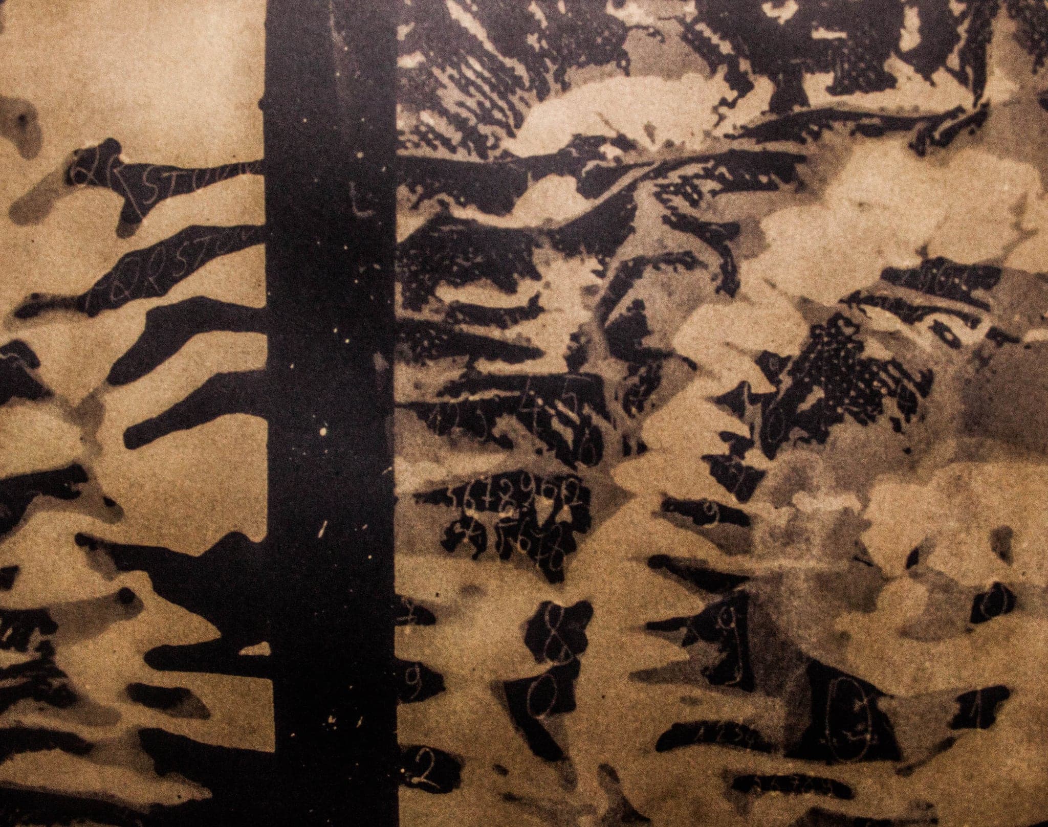 A wide sheet of gold and black torn bands, the bleach eaten through in ragged strips.
