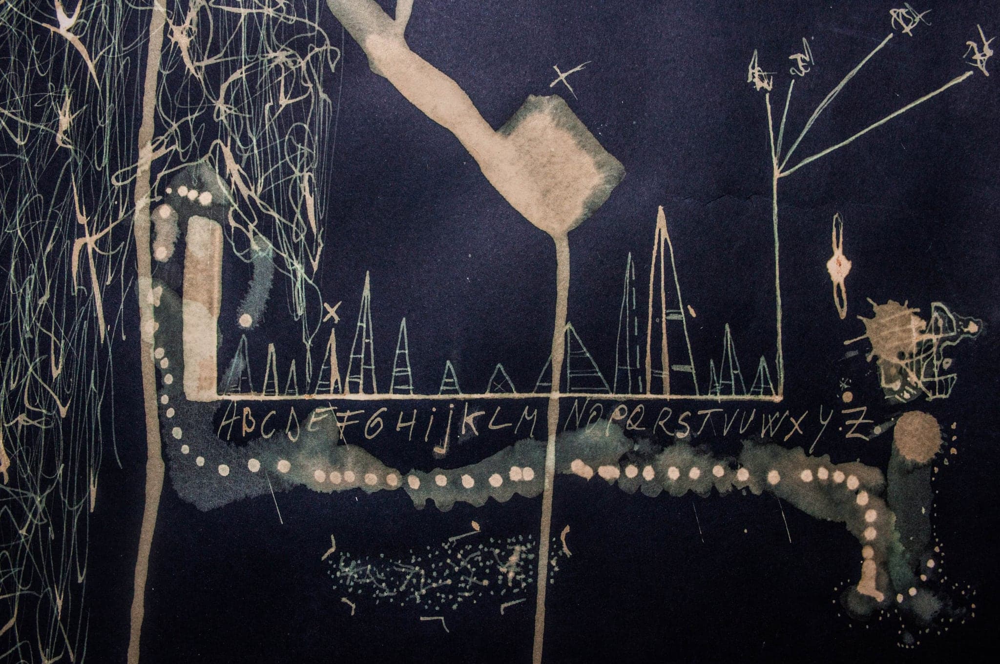 A pale ladder of letters running across the sheet with a form hanging from it.