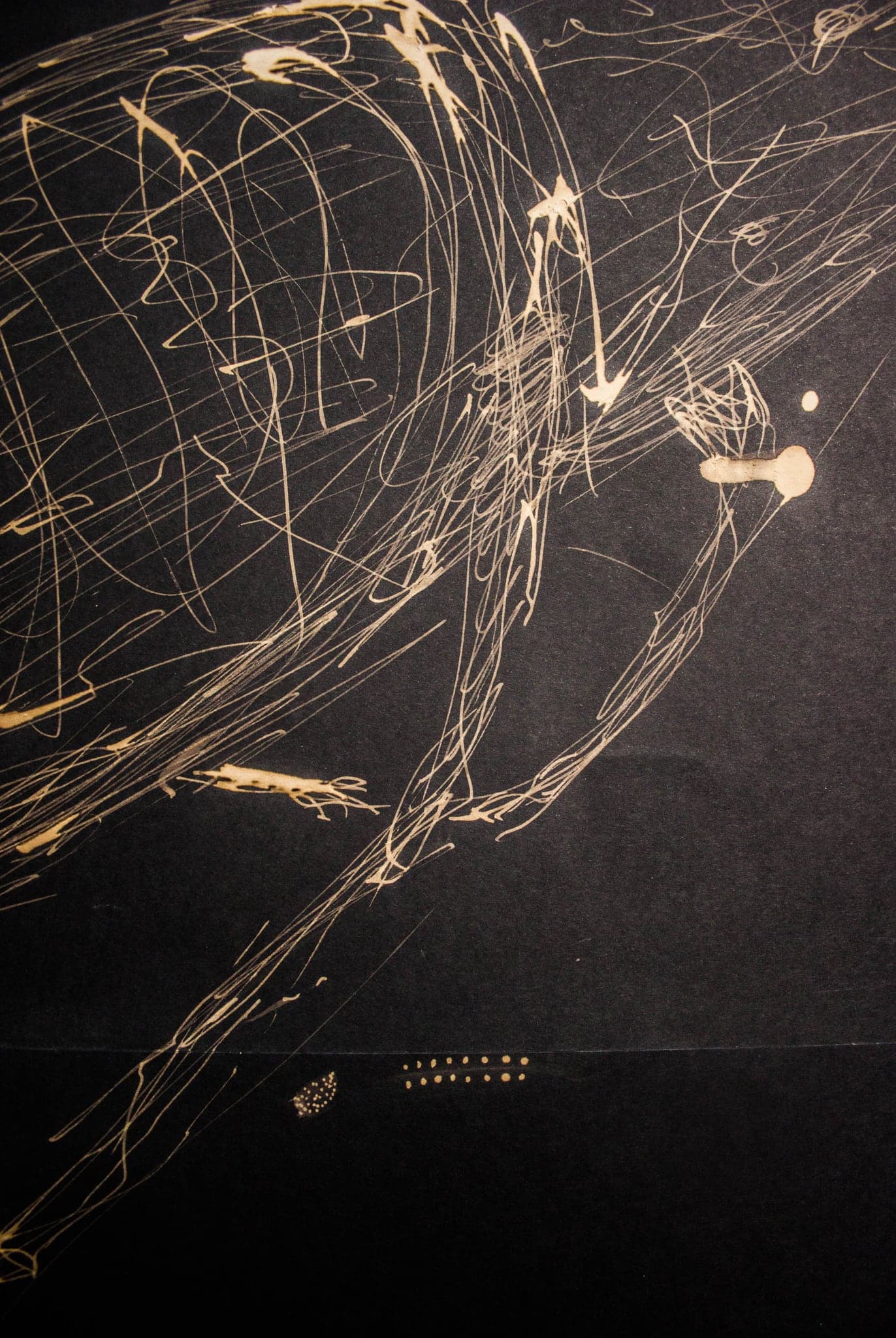 A fine gold cage of overlapping lines, dense at the top and opening out below.