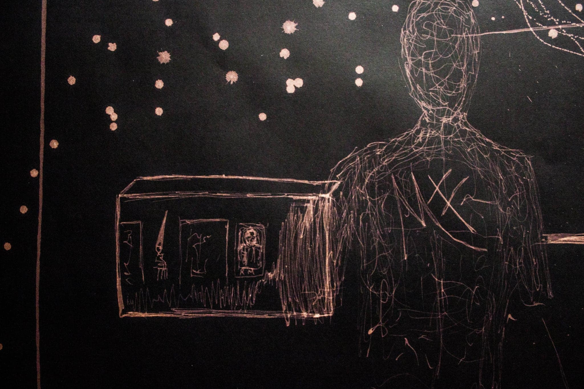 A standing figure outlined in dots, small drawn panels floating around it.
