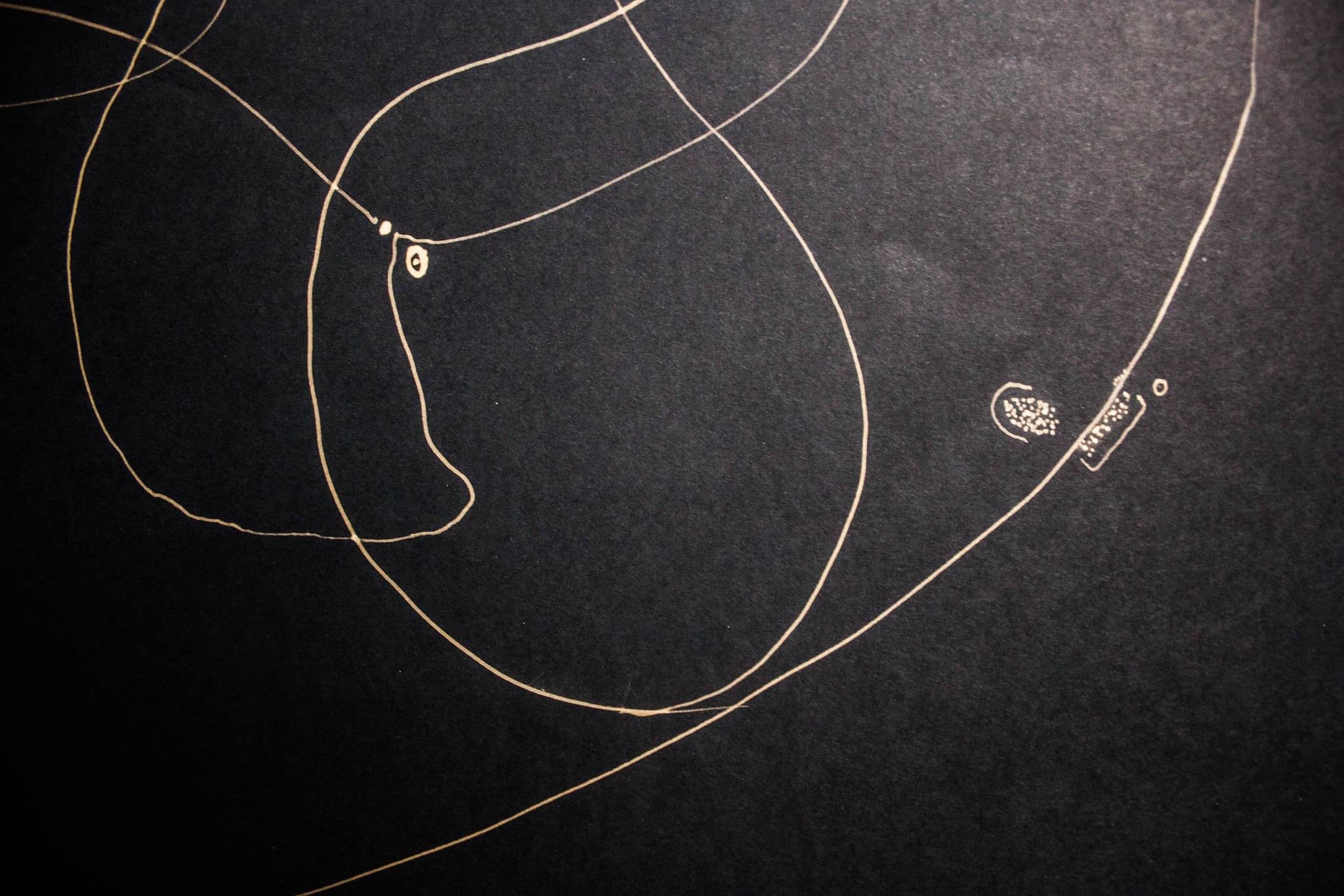 A long fine curve travelling the width of the sheet, a small drawn tag at its turn.