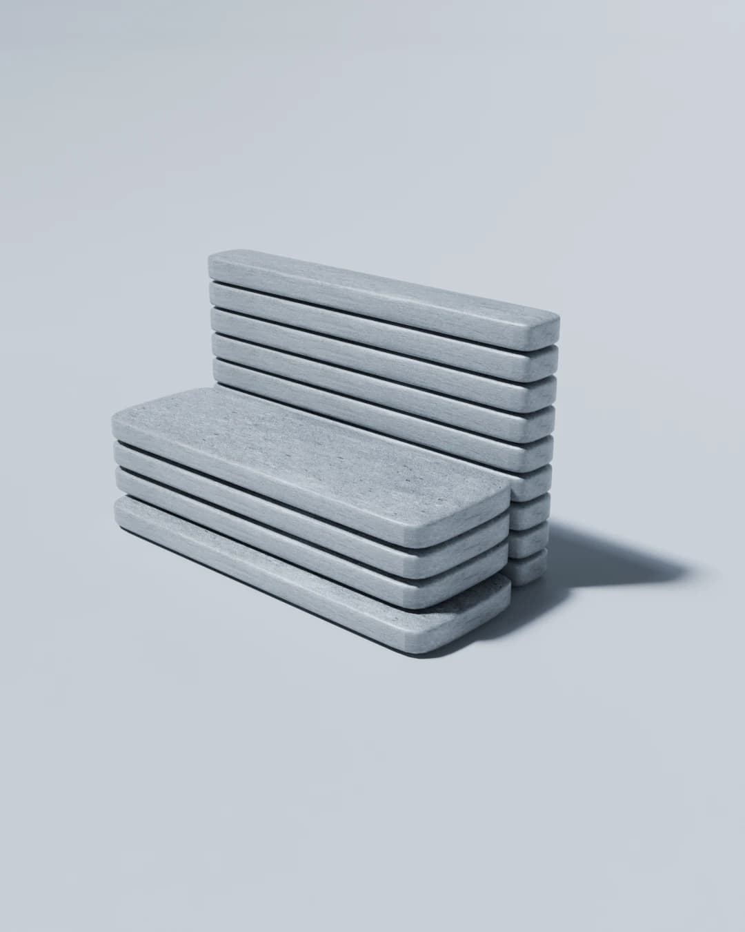 Three-quarter view of a concrete bench made of flat slabs stacked with open gaps, on a pale grey background