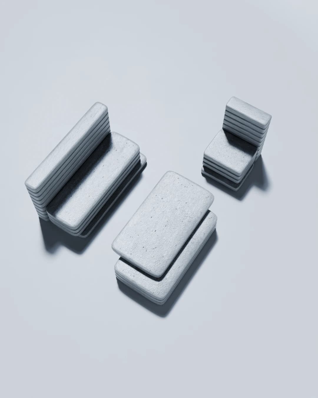 Overhead view of the full set — bench, chair and low table — all built from the same stacked concrete slab