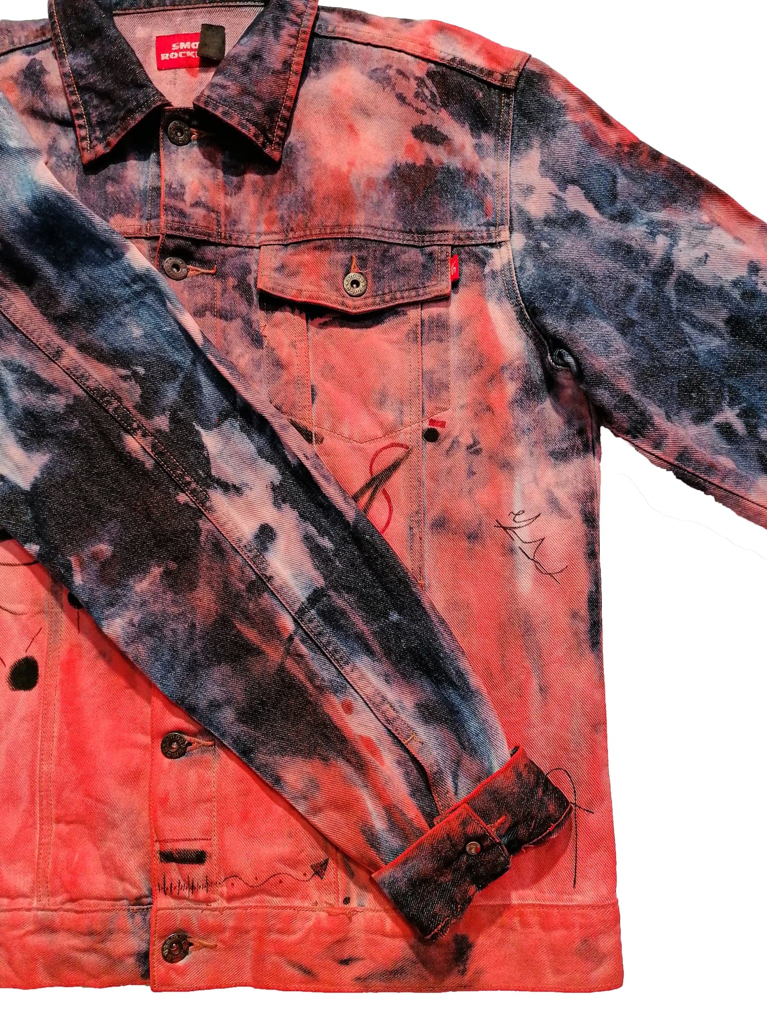 The jacket folded on white, the collar with its red label and one darkened sleeve
