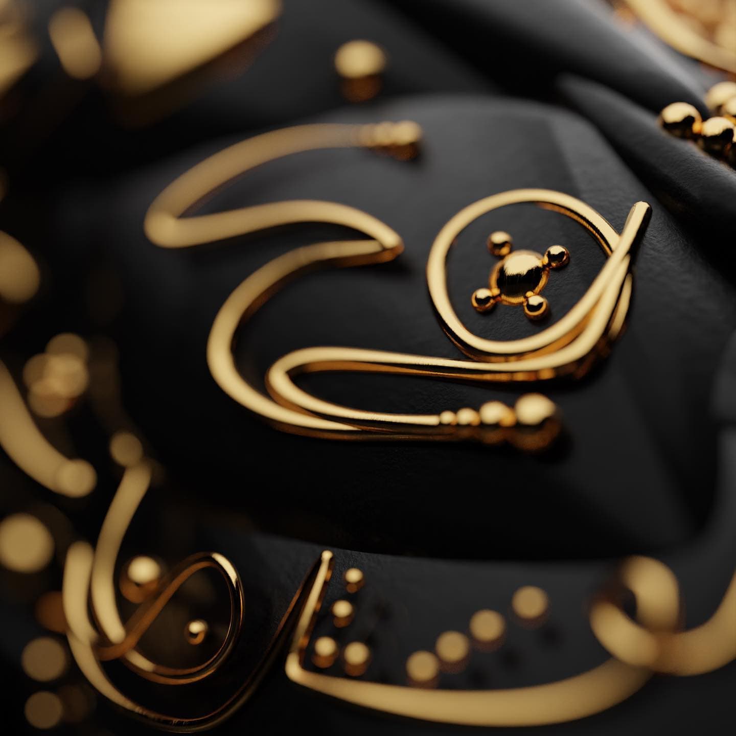 A close view of the gold linework, the strands doubling back and gathering into small beads where they meet