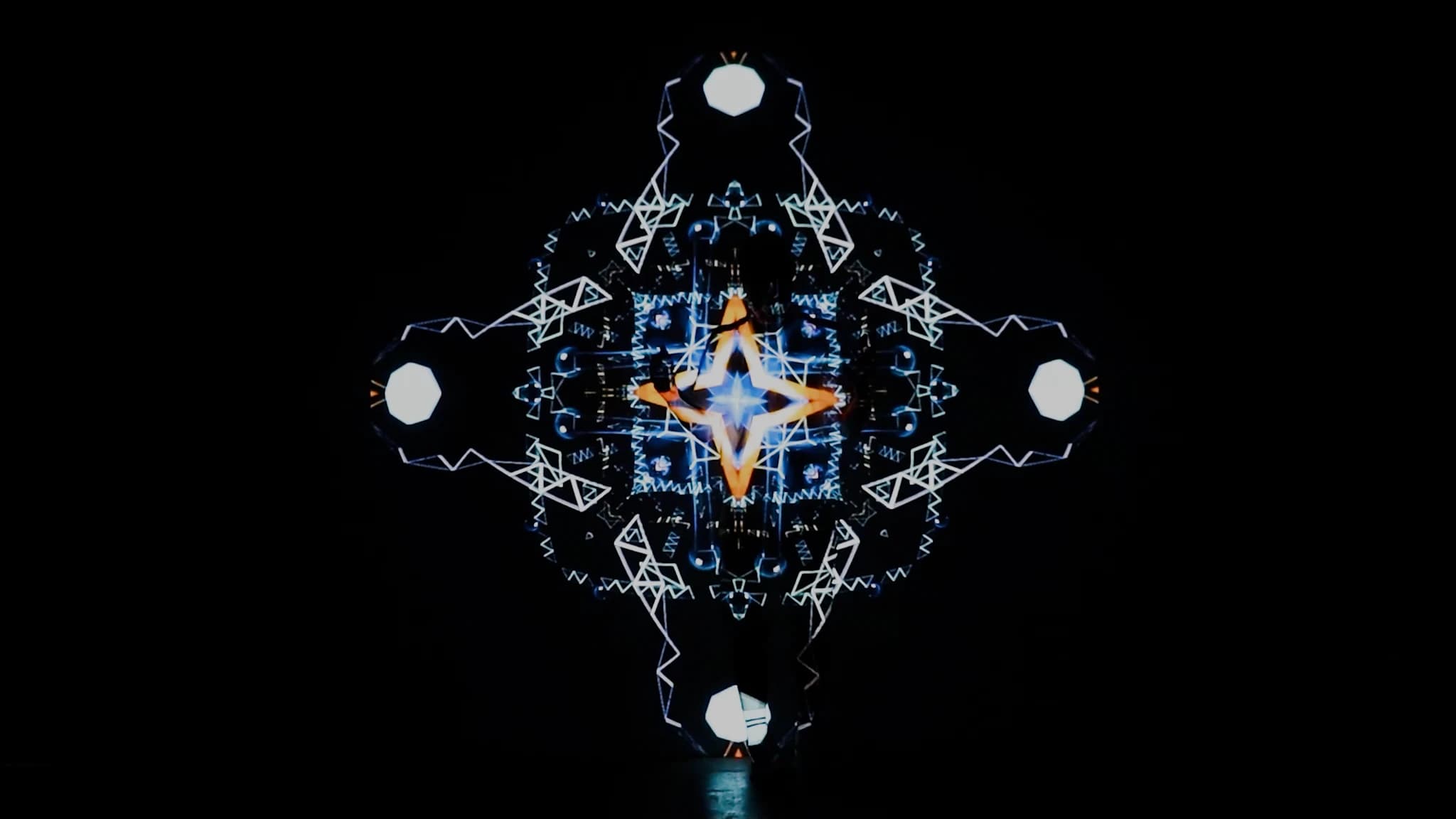 The pattern thinned almost to line, a small orange star held at the middle