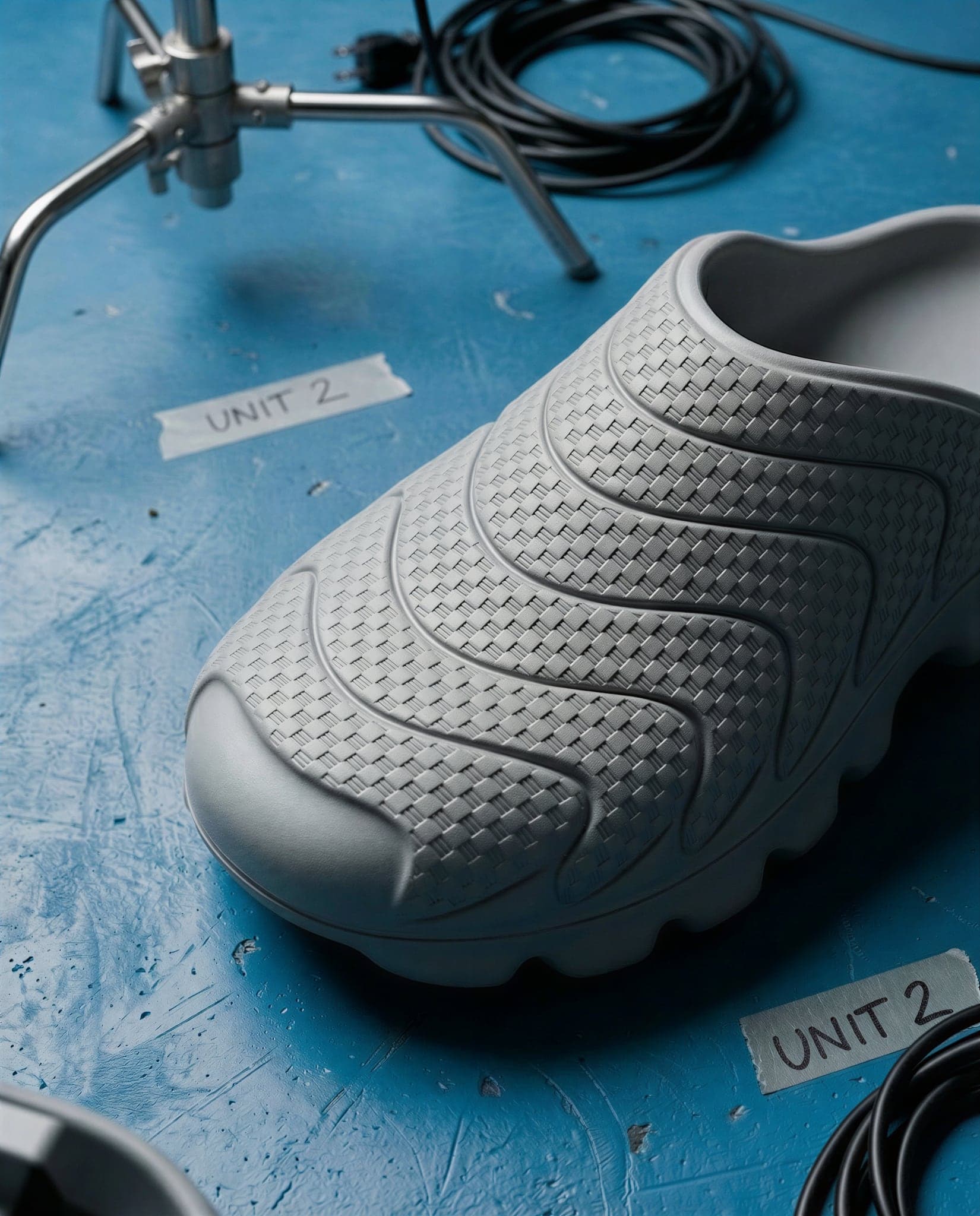 Close-up of the mule's toe and midfoot showing the fine woven texture inside each wave band and the rounded lugs below.