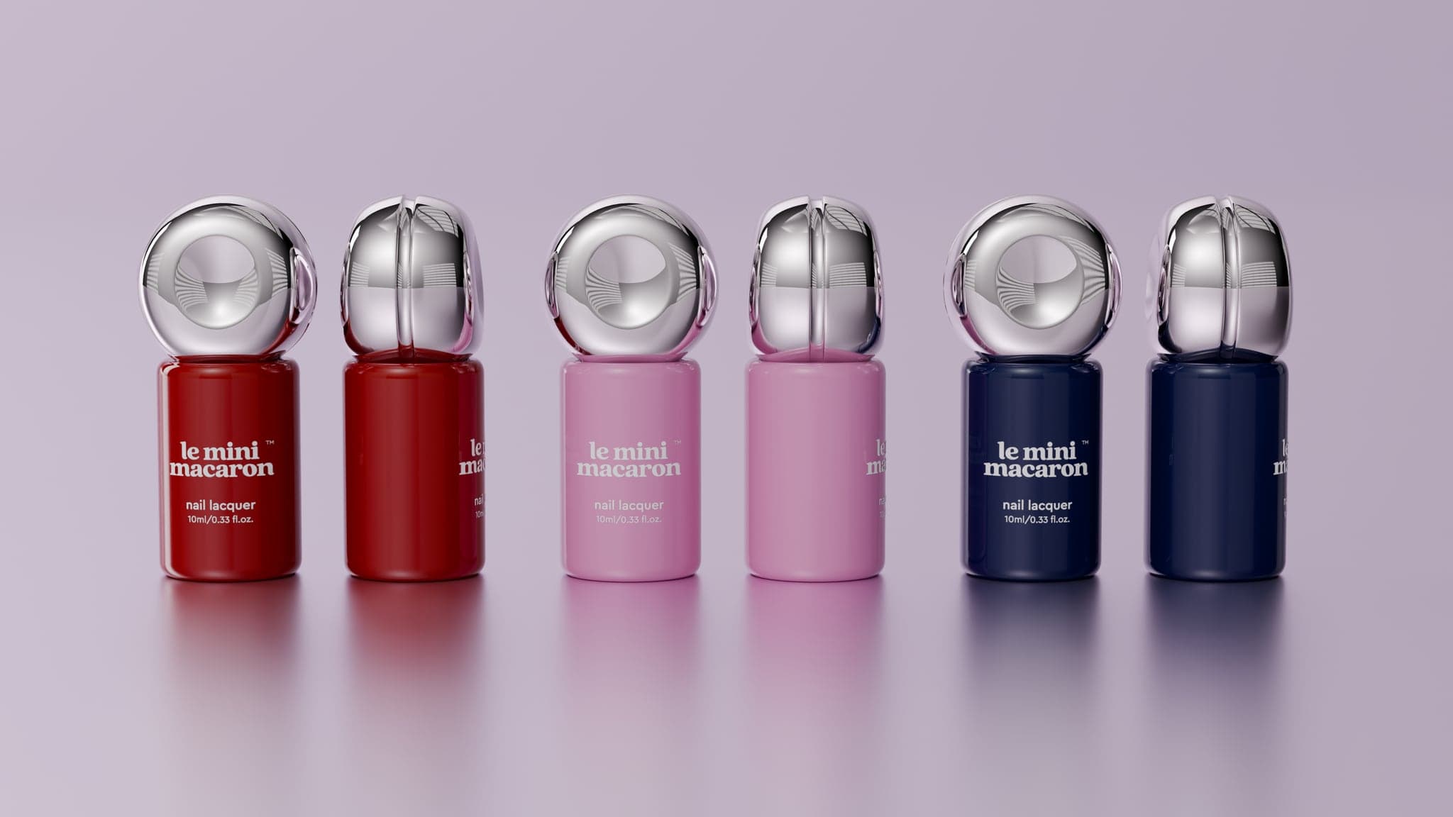 Six nail lacquer bottles in a row — red, pink and navy pairs — each capped with a chrome sphere, shown closed and part-opened
