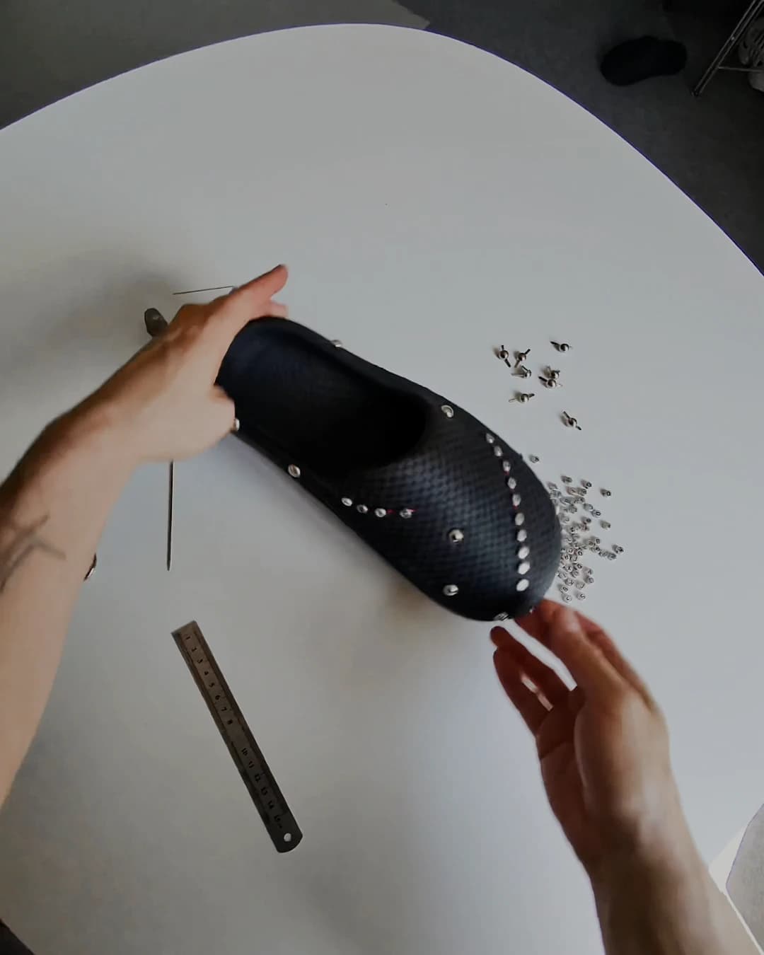 Overhead view of the finished shoe, the full run of studs and beads reading as a single line down the flank