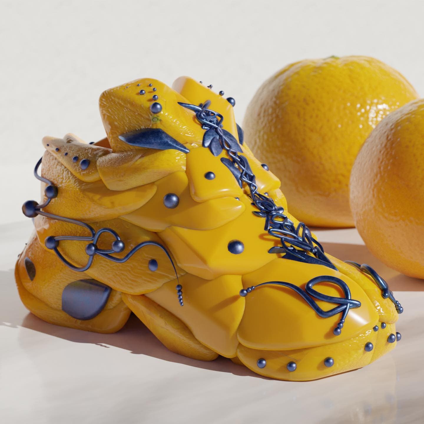 A yellow-orange sneaker with a pitted orange-peel surface and blue-grey wire looping across it, standing among real oranges on a white ground