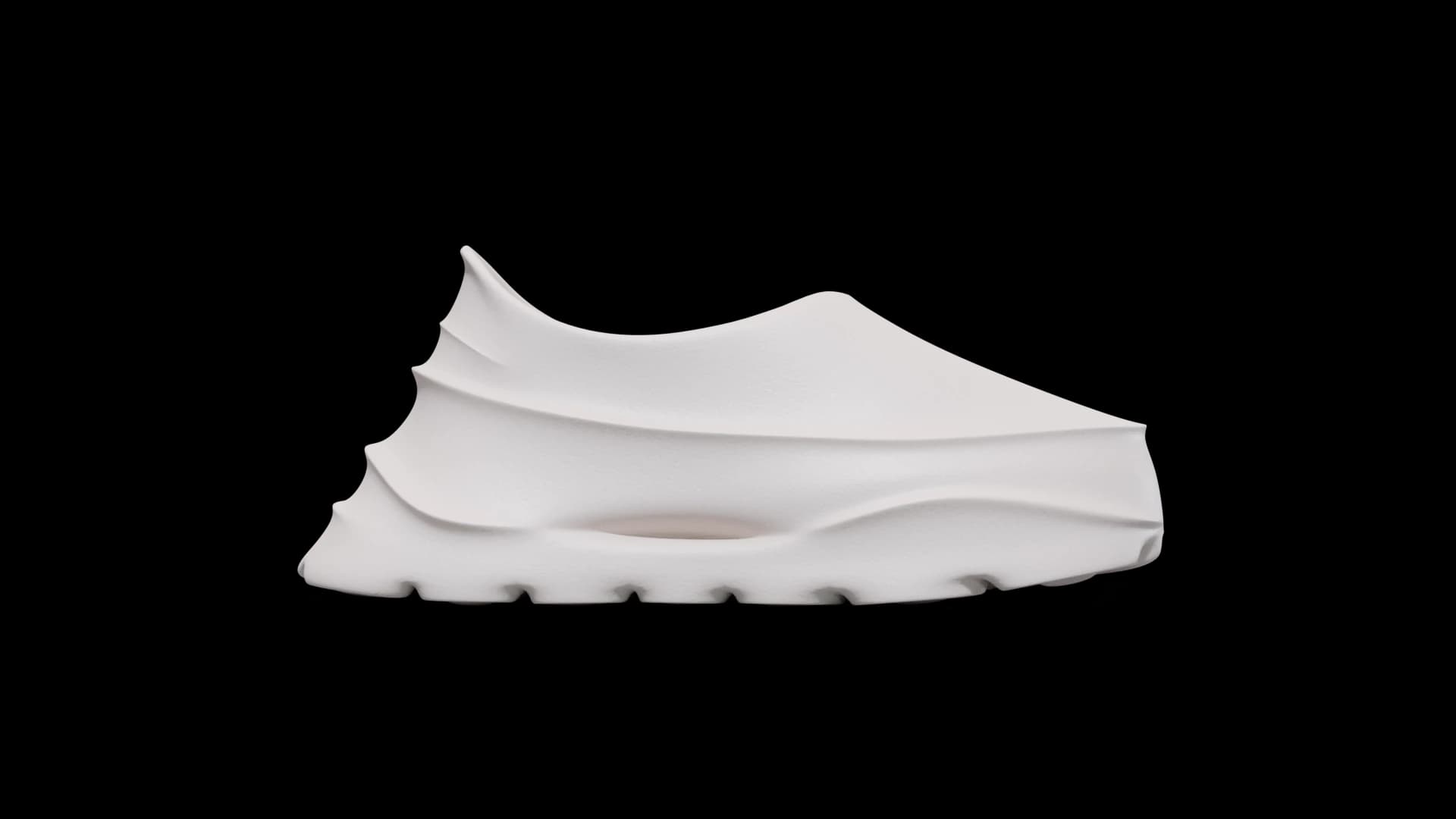 Side profile of a single white slip-on sneaker against a dark grained background, the collar stepping down in shallow ledges toward the toe.