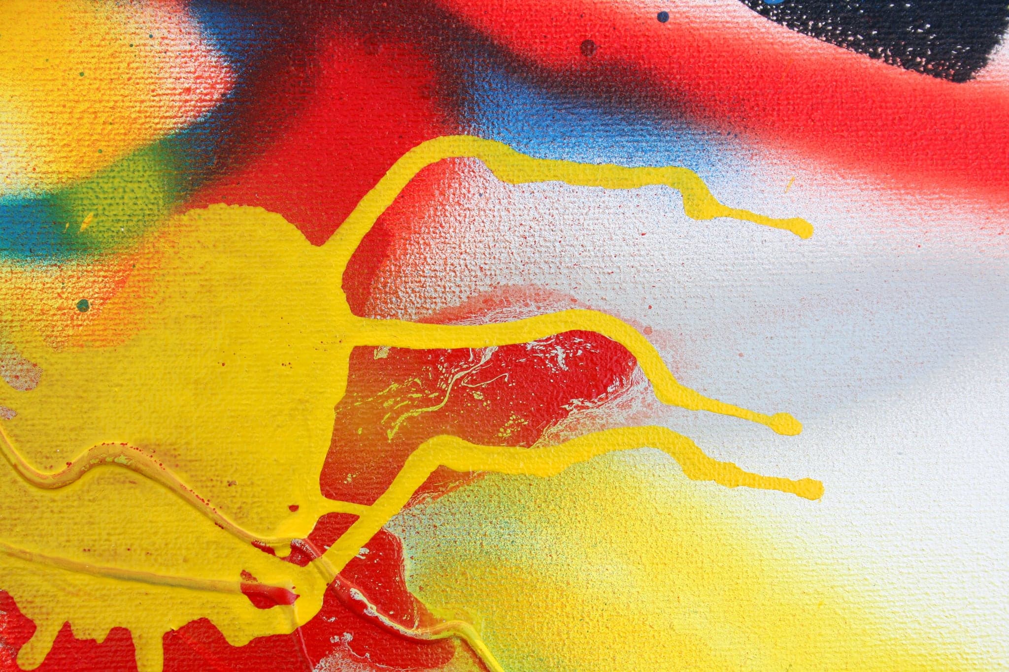 Close view: orange fingers running down through a yellow field, red behind.