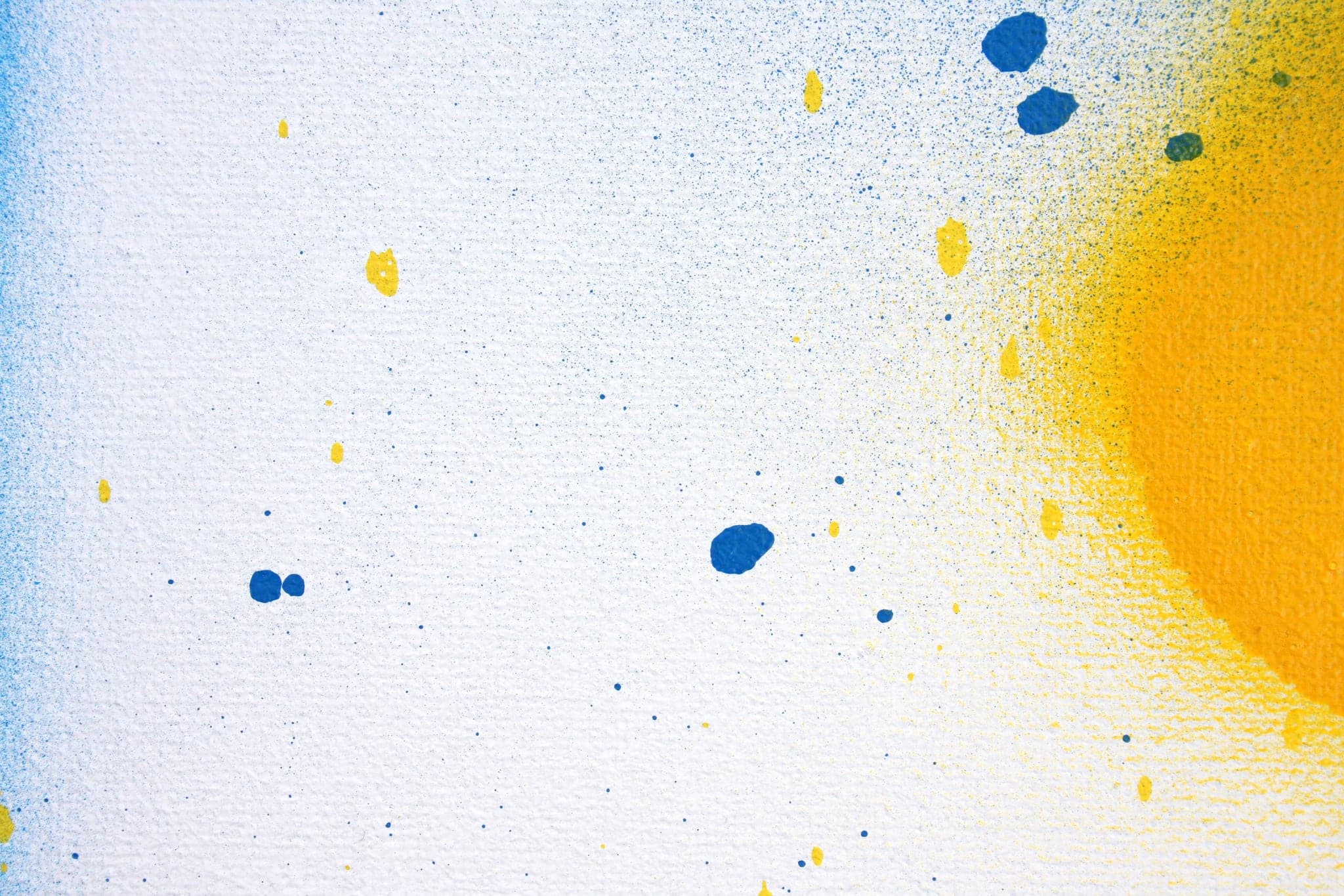 Close view: blue flecks and a yellow edge on almost bare white.