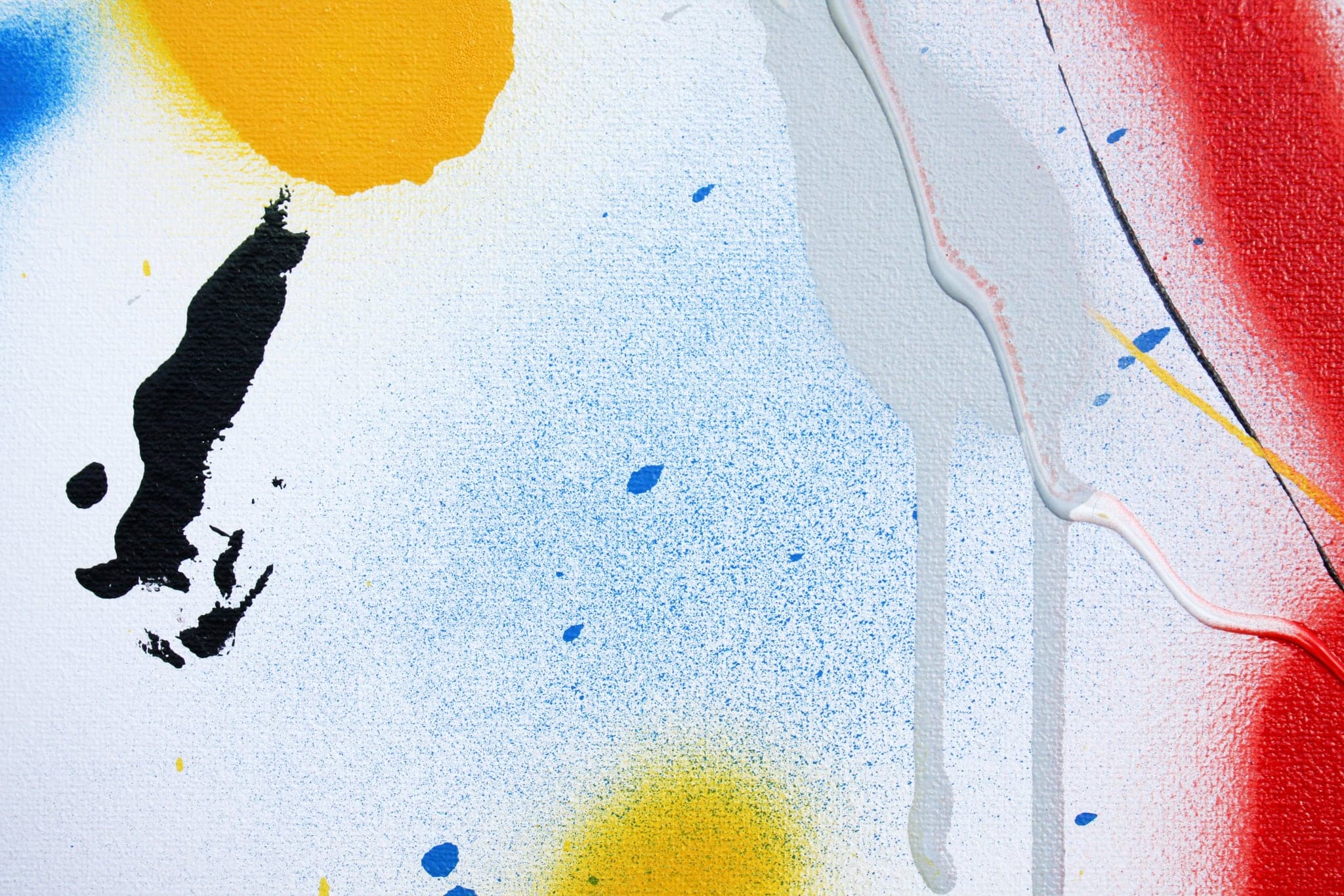 Close view: the black mark, the yellow blob and the grey drips together.