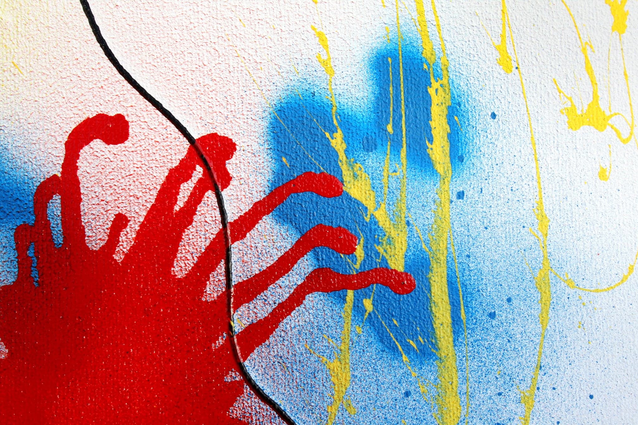 Close view: the red burst throwing fingers out over blue and yellow.