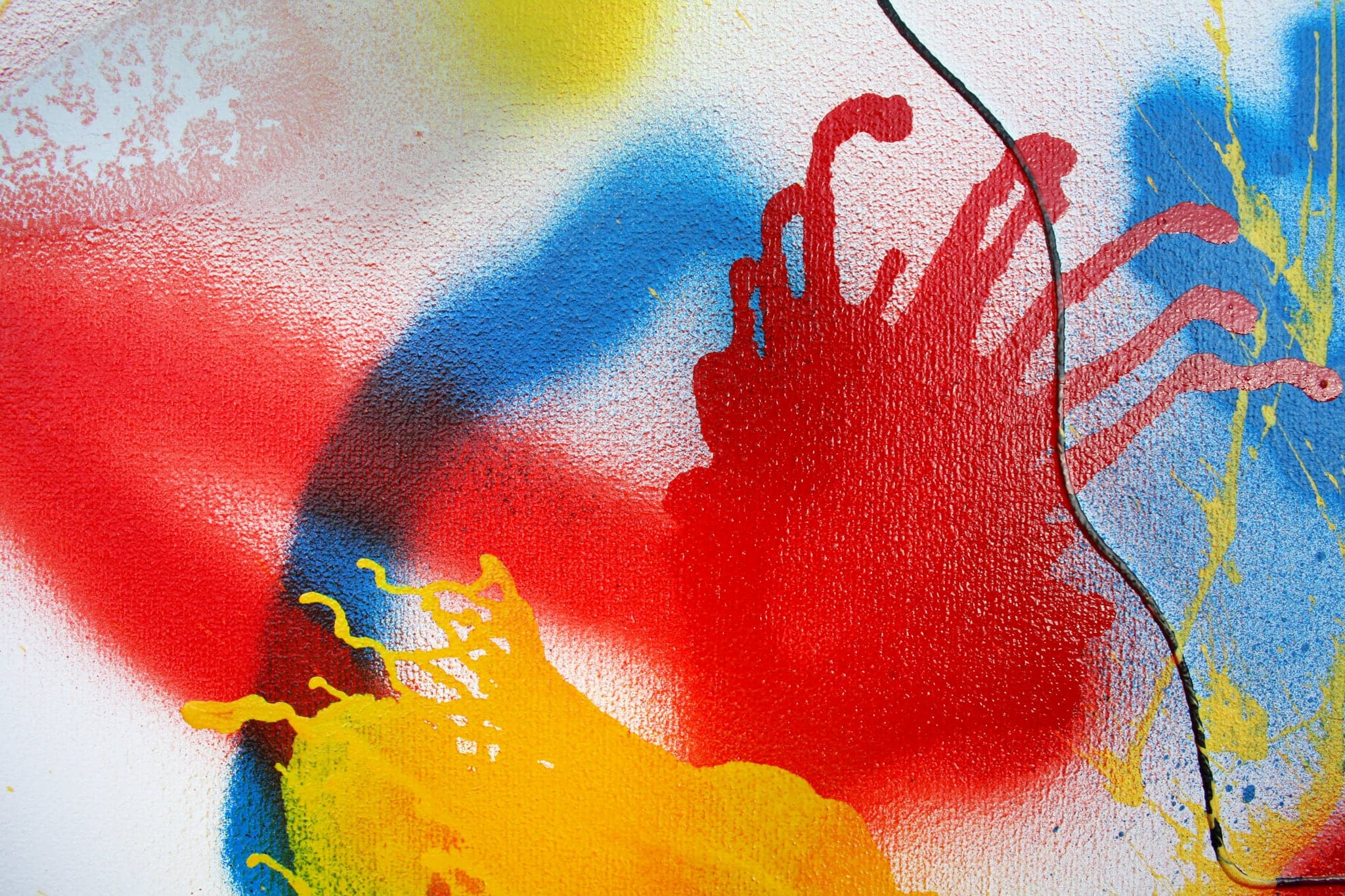 Close view: red fingers against blue, the white barely showing.