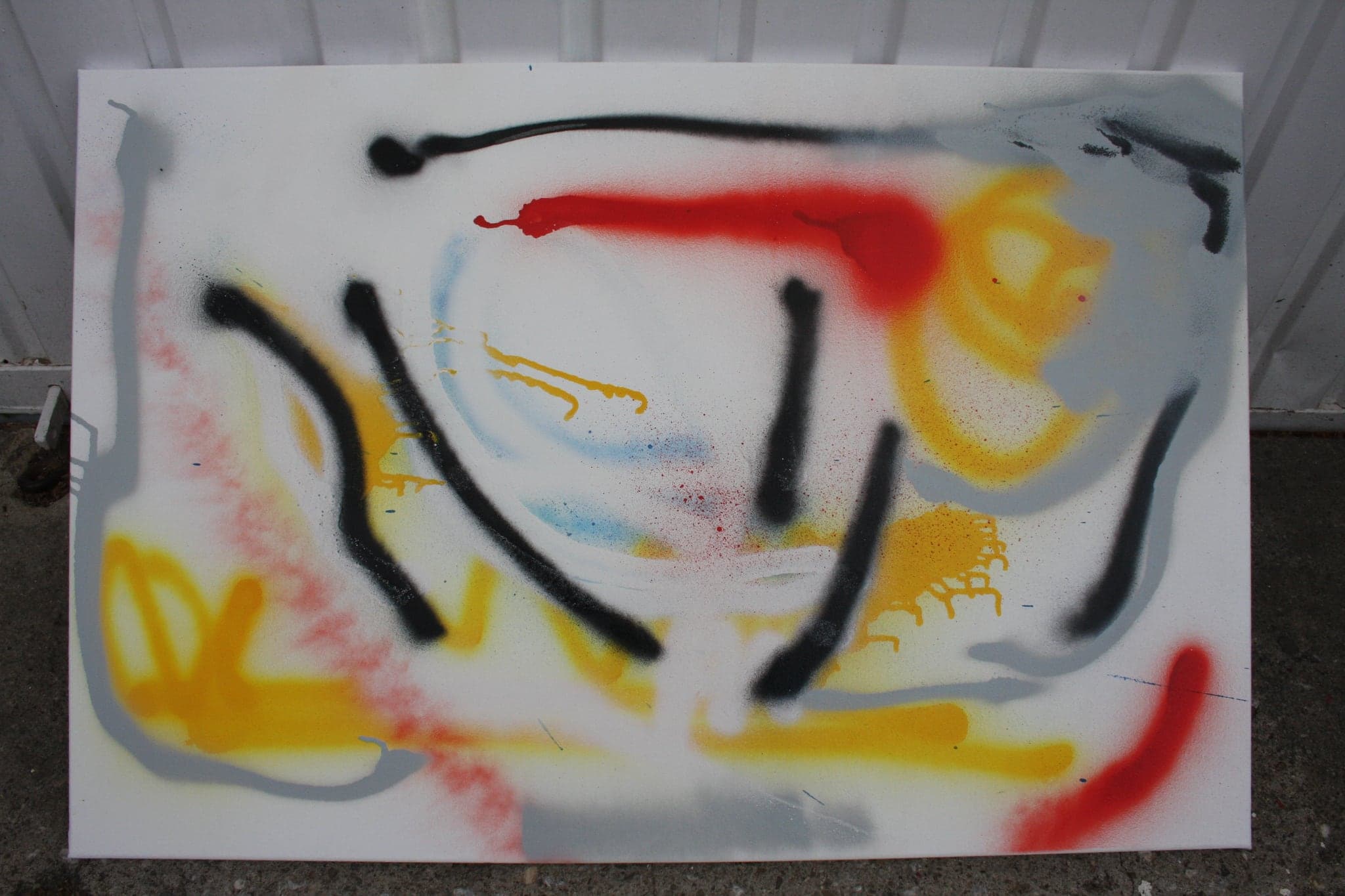 The same canvas standing against a studio wall on a concrete floor.
