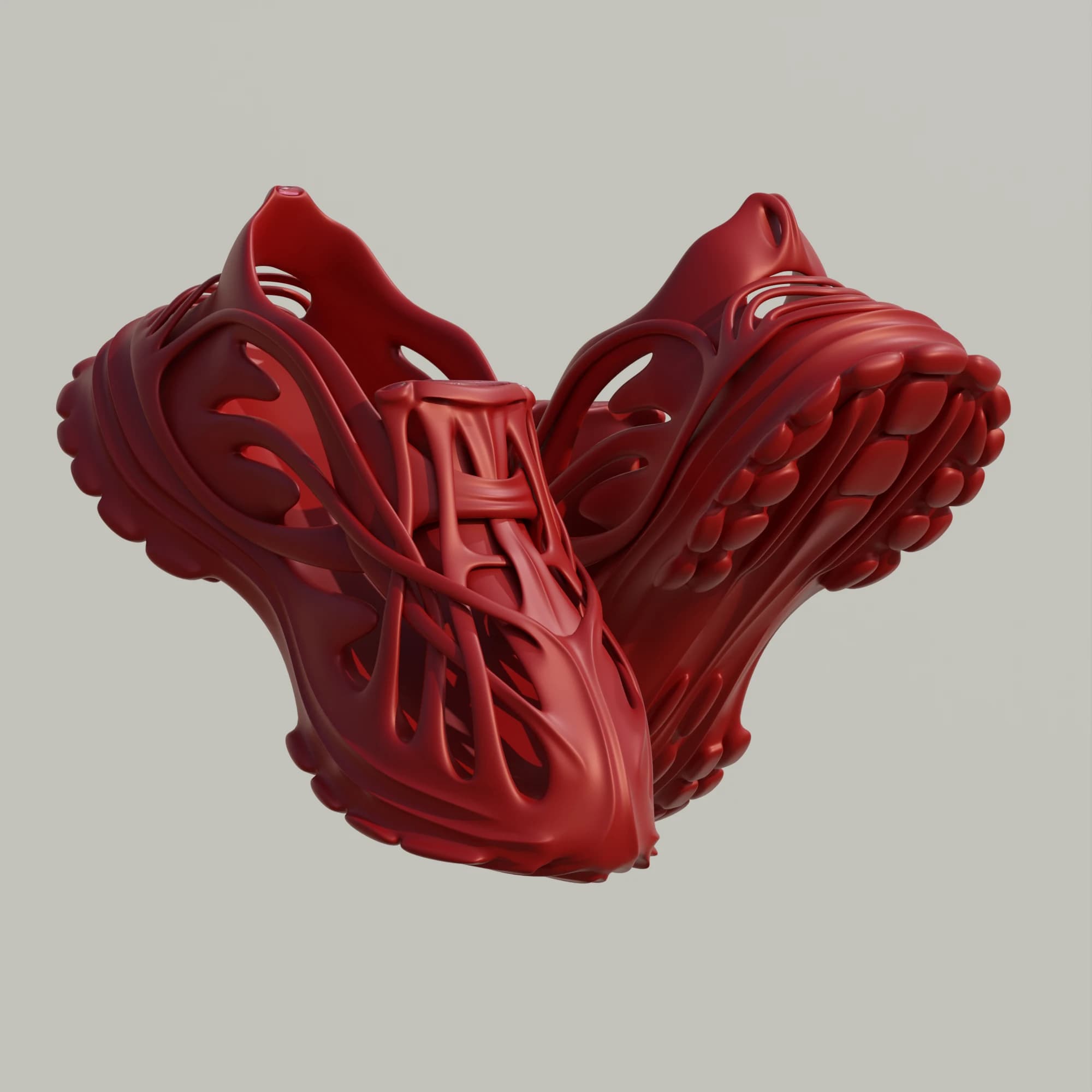 A pair of red monoblock sneakers floating heel-to-heel on a pale grey background, showing the ribbed cage upper and the lobed outsole