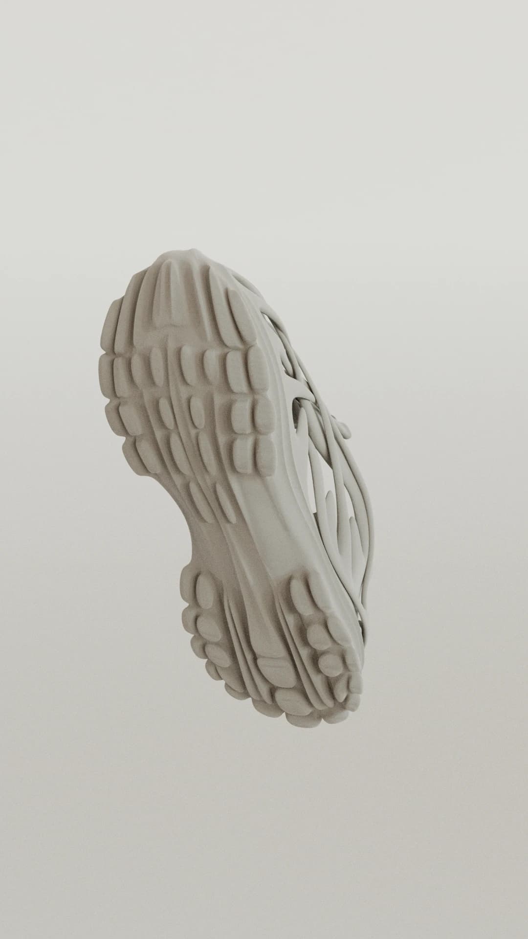 A single off-white shoe tilted in mid-air against a pale background, showing the full lobed tread pattern of the outsole
