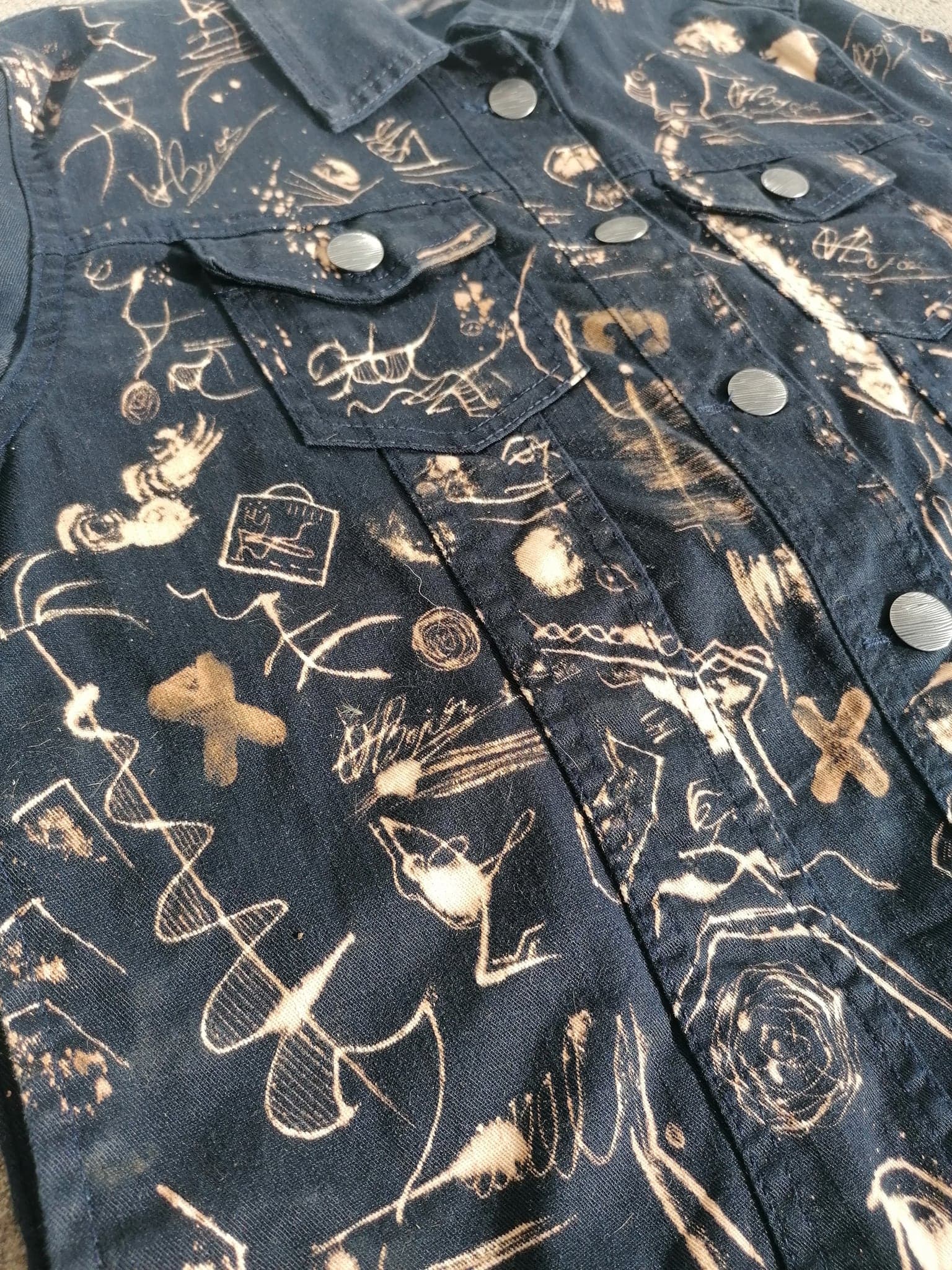 A close view across the chest, crosses and ladders and a small standing figure