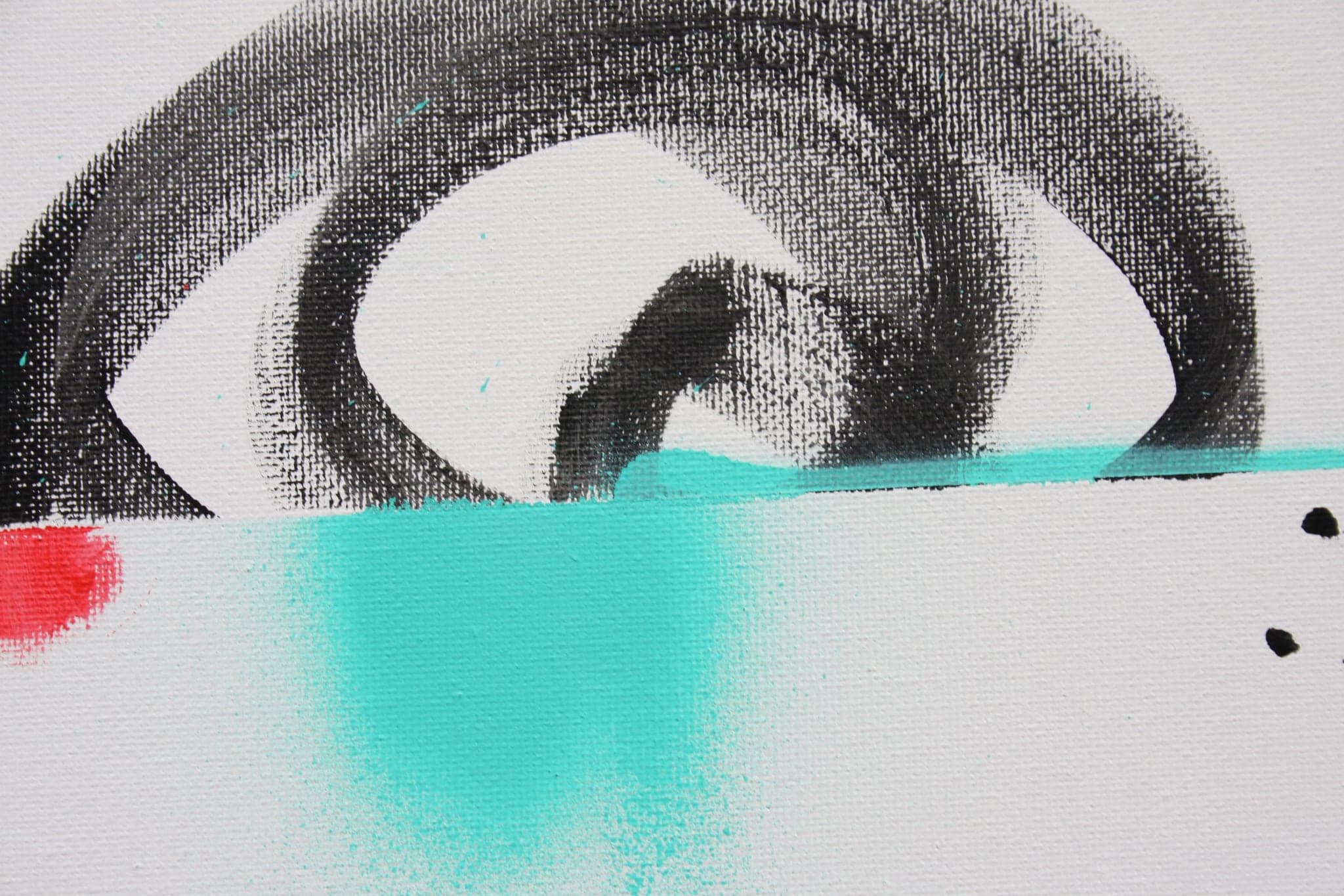 Close view: a dark spiral over a turquoise wash, red marks caught at its edge.