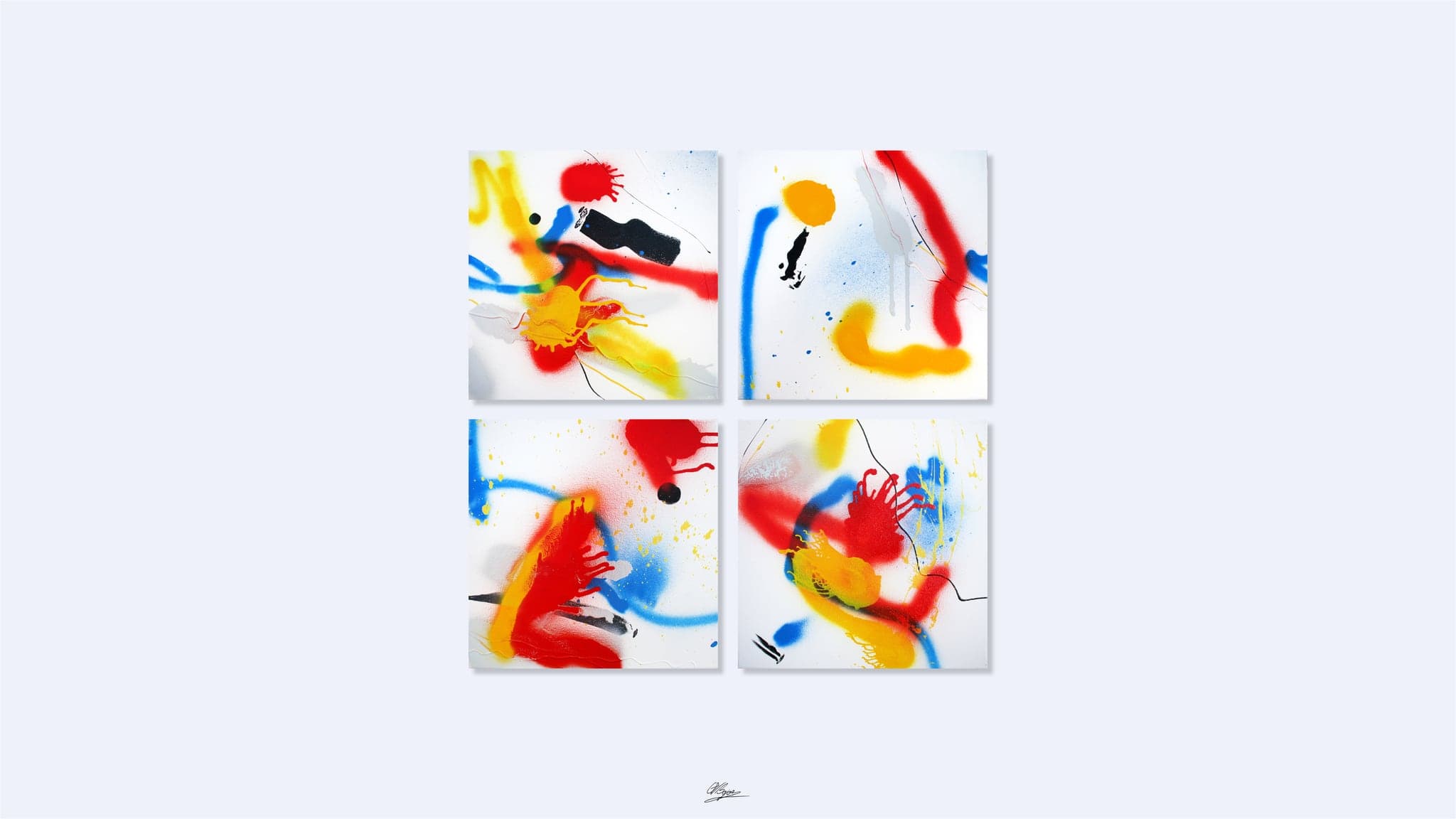 Four square canvases hung in a two-by-two block, each sprayed with red, yellow and blue bursts on white.