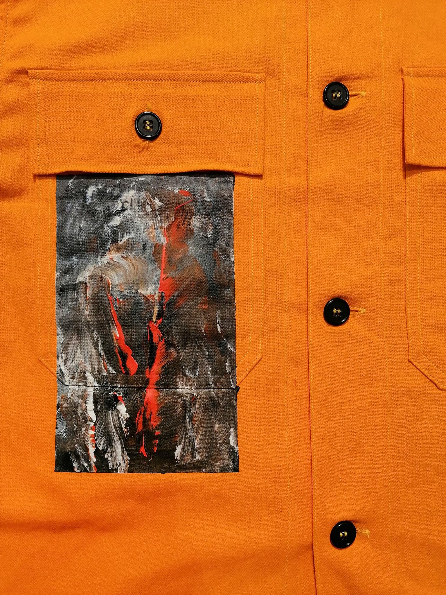 The chest panel close up, black and white brushwork with a single red line running down it