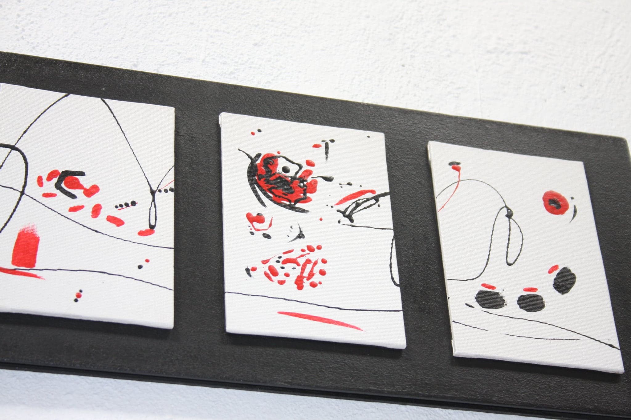 The same three seen from one end, the board running away at an angle so the panels line up in perspective.