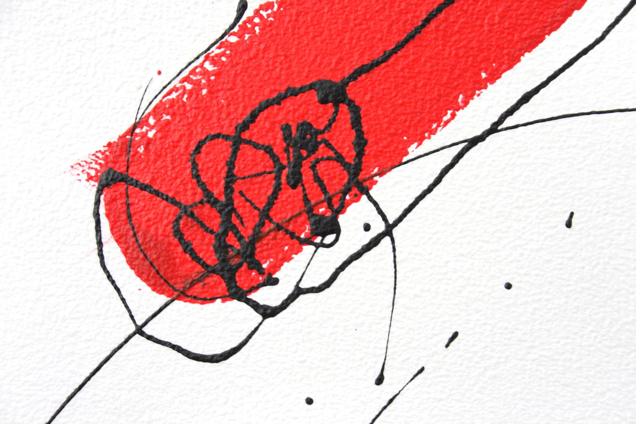 Close view of a broad red diagonal bar with a black scribbled knot drawn over its end