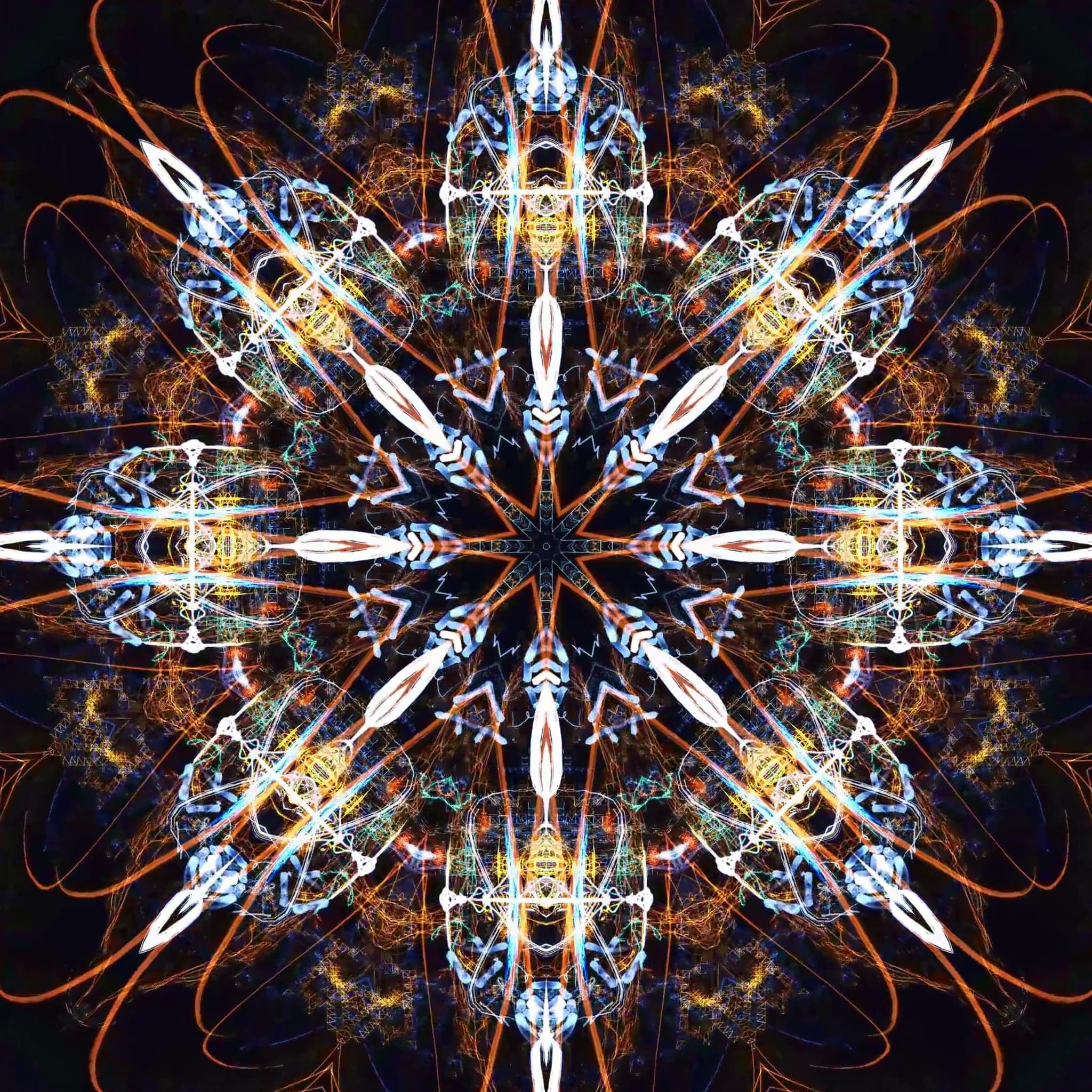 Orange rays and pale blue lozenges radiating from a dark hub, forming an eight-armed star on black.