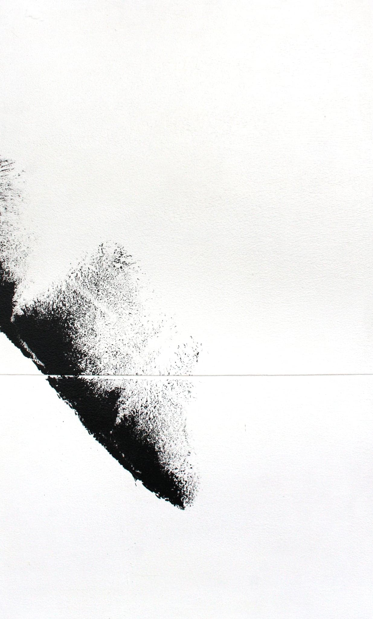 Close view of the tail of the black stroke breaking into dry spray across white canvas